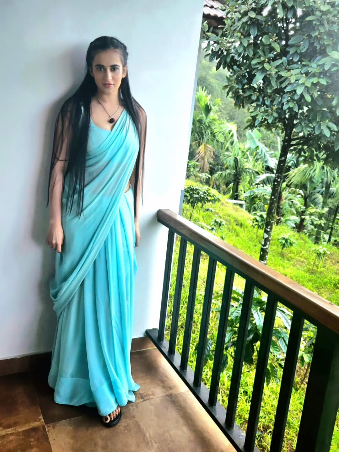 Thapaswini Poonacha timeless elegance in blue saree balcony view