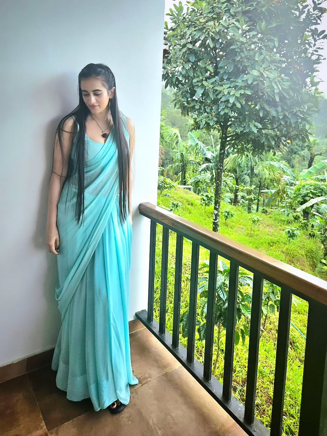 Thapaswini Poonacha stunning aqua saree with lush greenery