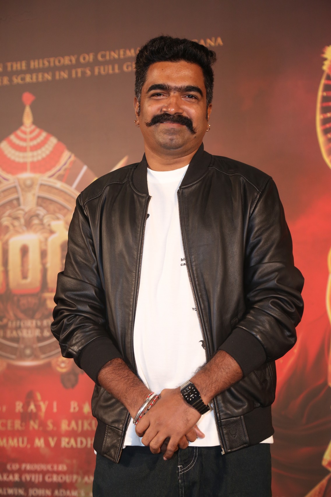 Ravi Basrur posing for media cameras