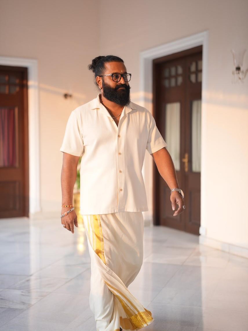 Rishab Shetty walking confidently in traditional dhoti look