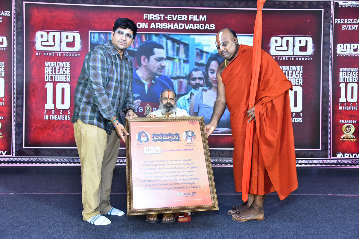 Director with Jeeyar Swami standing on stage