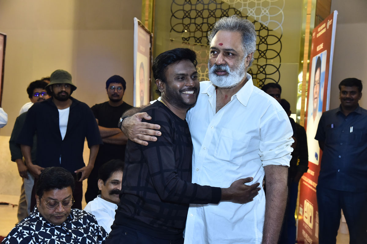 Music director hugging producer during event