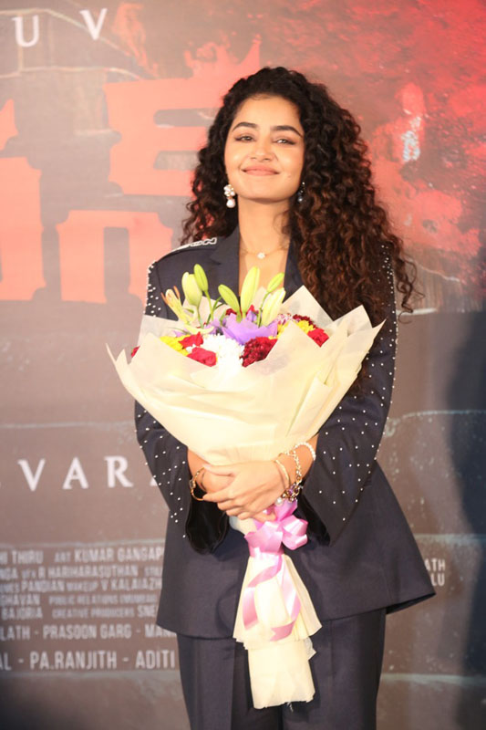 Anupama Parameswaran holding flower bouquet smiling