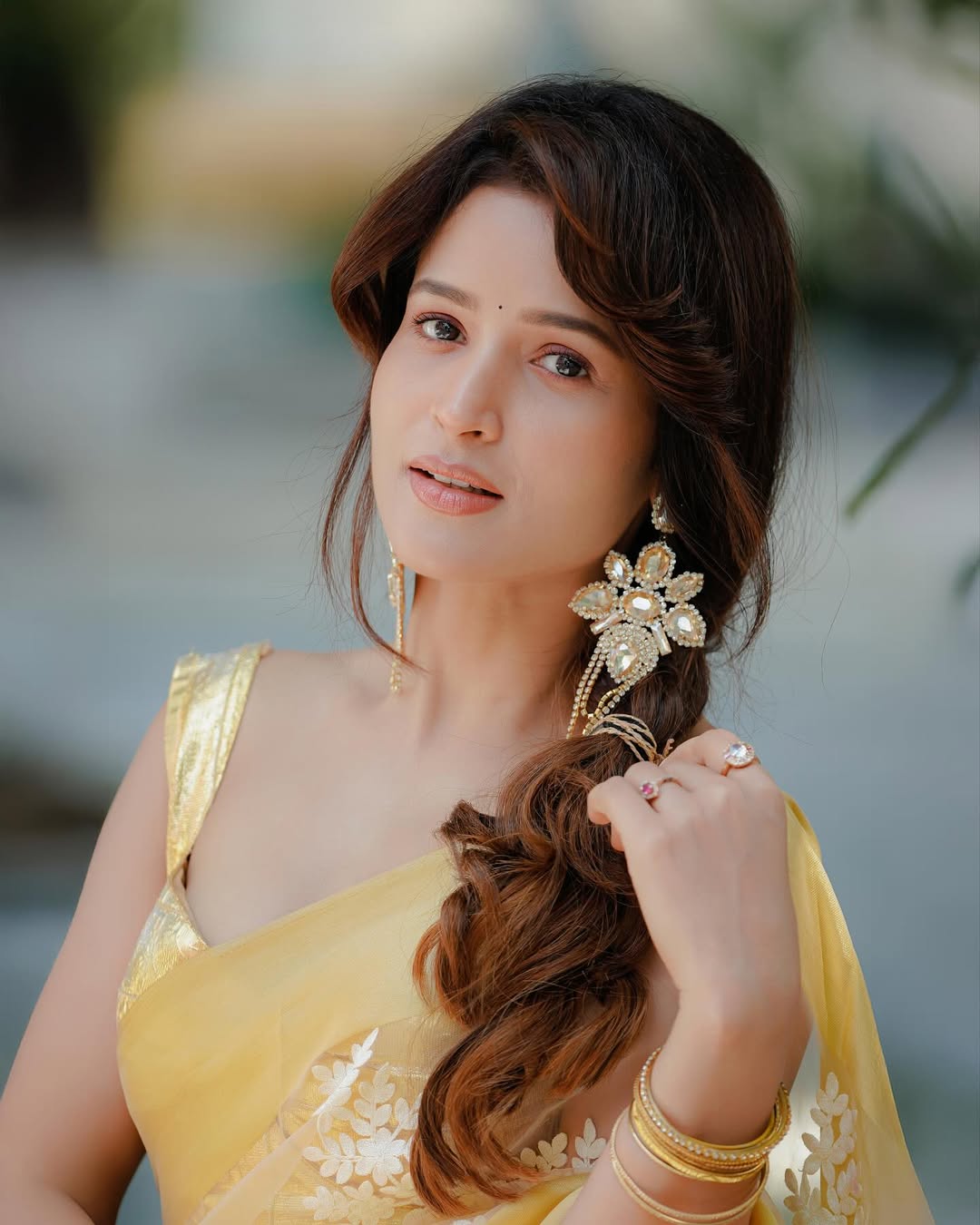 Brinda Acharya stuns in golden saree with playful charm