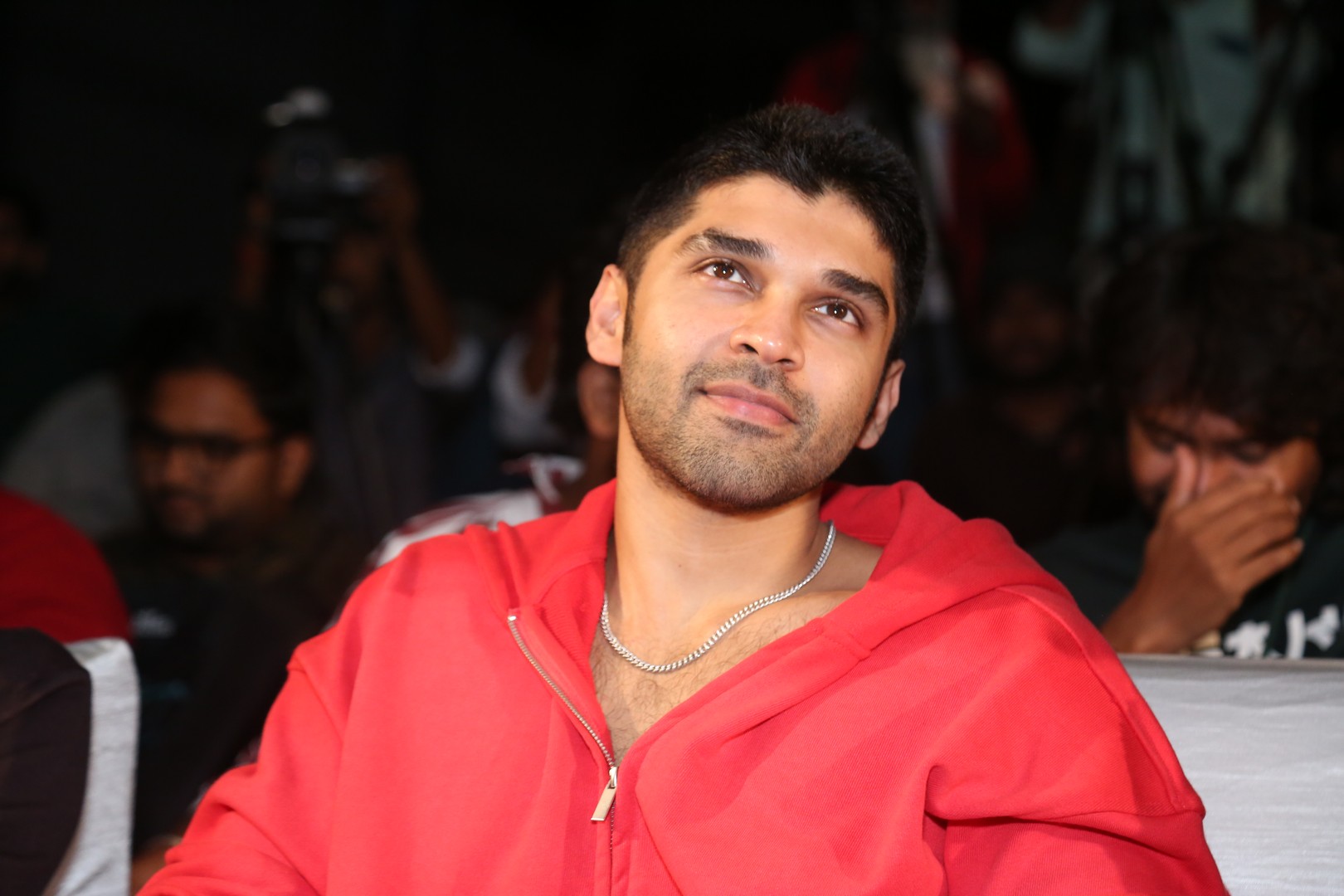 Dhruv Vikram exudes effortless charm and casual red hoodie style