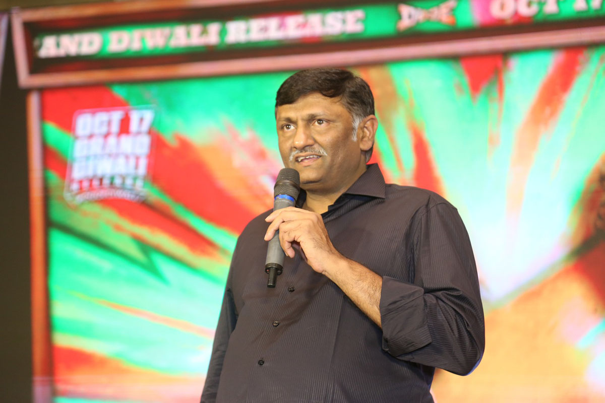 Naveen Yerneni giving speech on stage