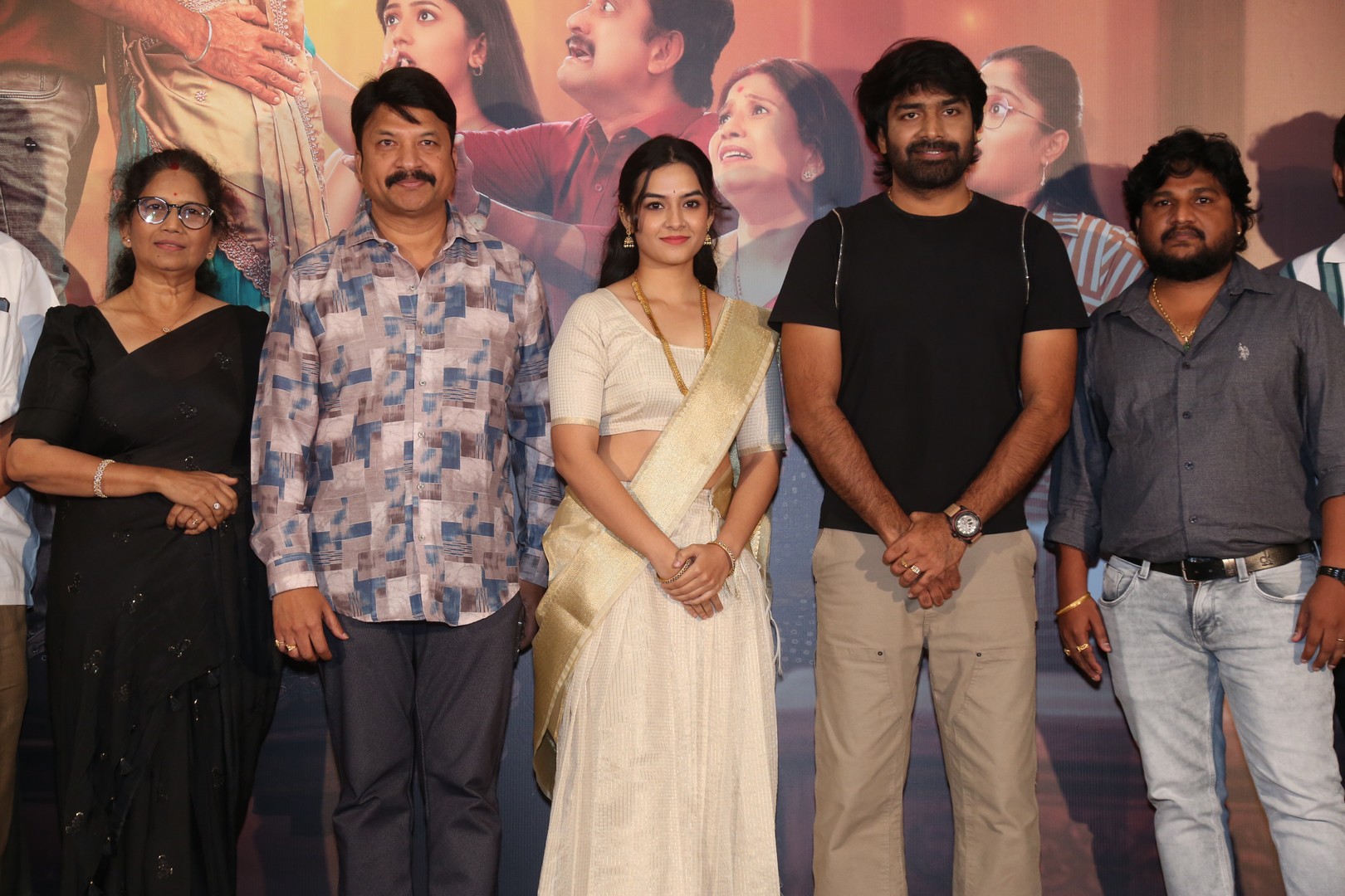 Filmmakers and actors smiling during media interaction