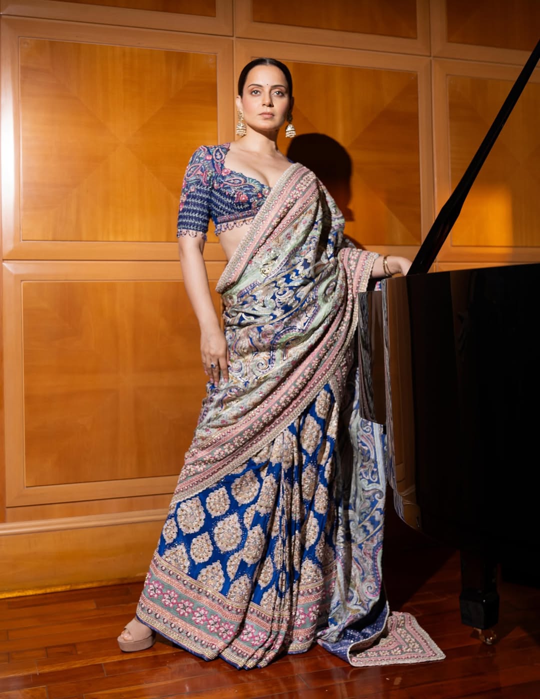 Kangana Ranaut elegant in saree beside piano exuding timeless grace