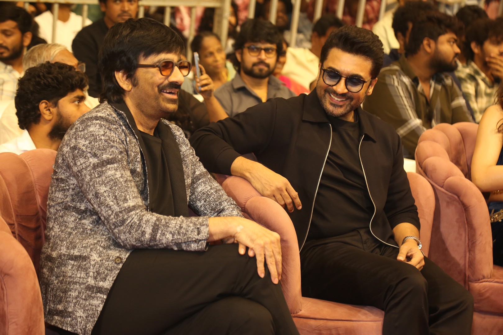 Ravi Teja and Suriya talking with smiles at event