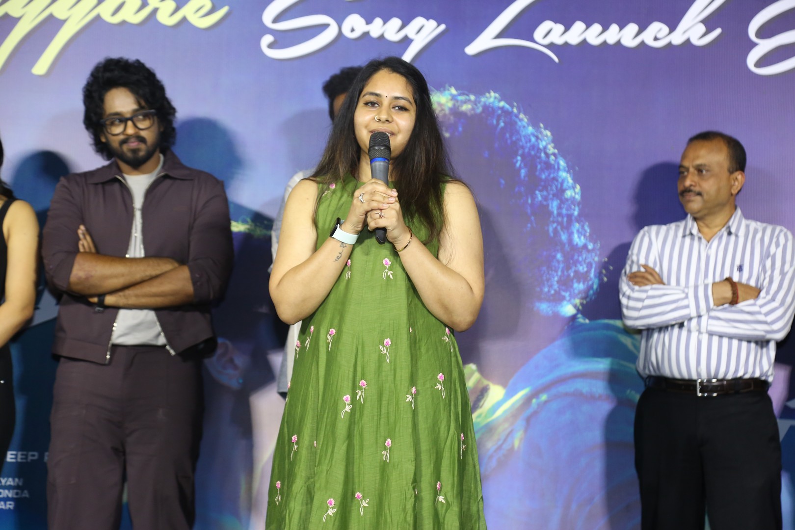 Producer Krithi Prasad giving speech on stage