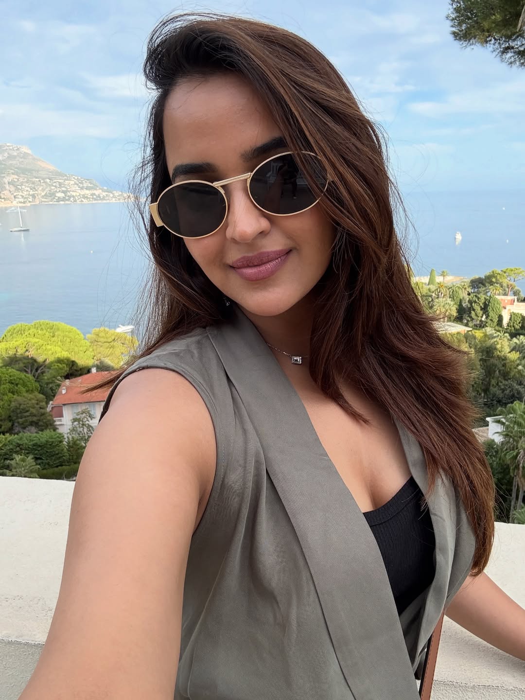 Pujita Ponnada looking chic in sunglasses with scenic view