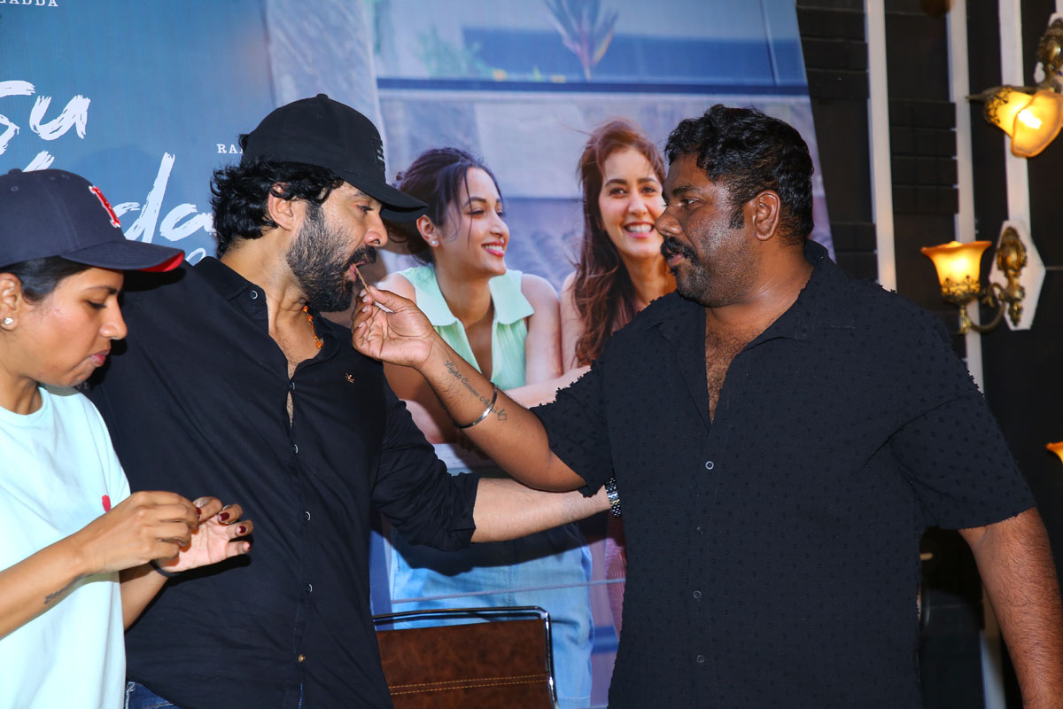 Harsha Chemudu feeding cake to Siddu Jonnalagadda at celebration event
