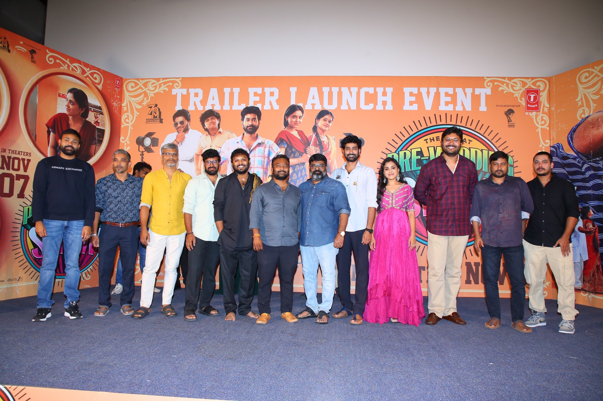 Star cast standing on stage during photo session