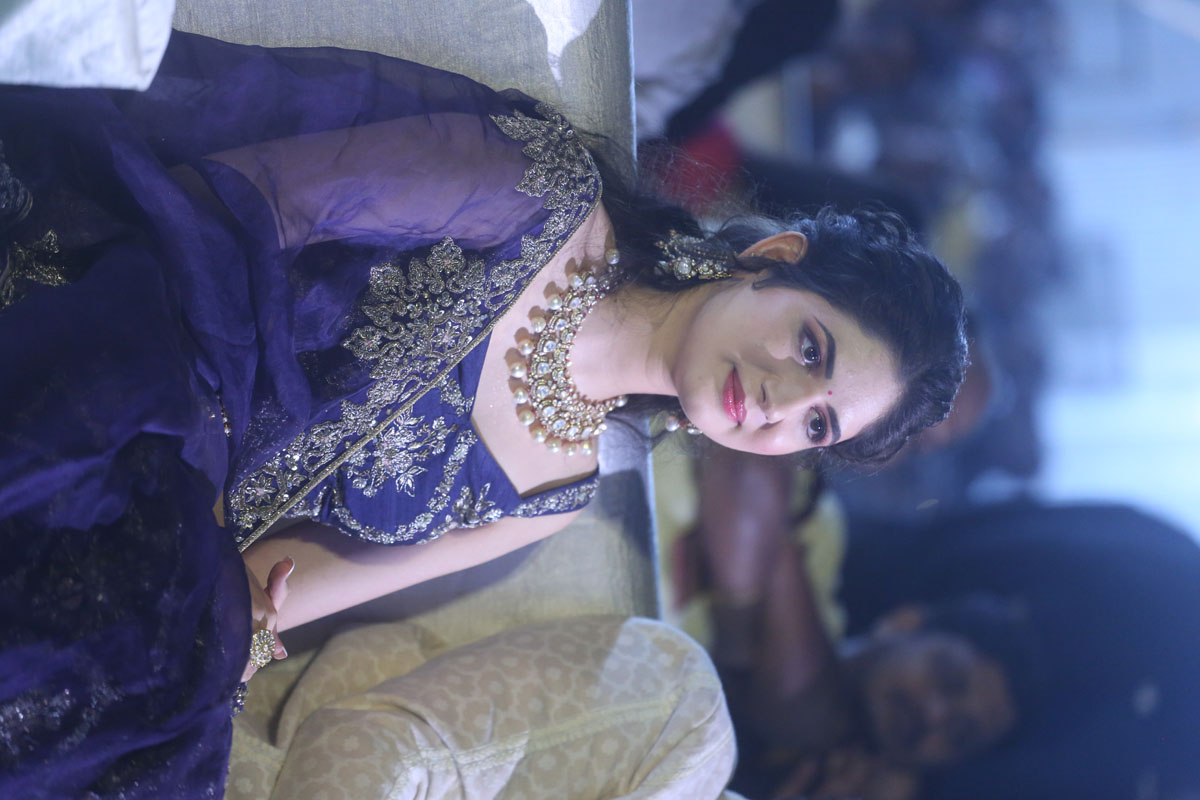 Harshaali Malhotra seated at event