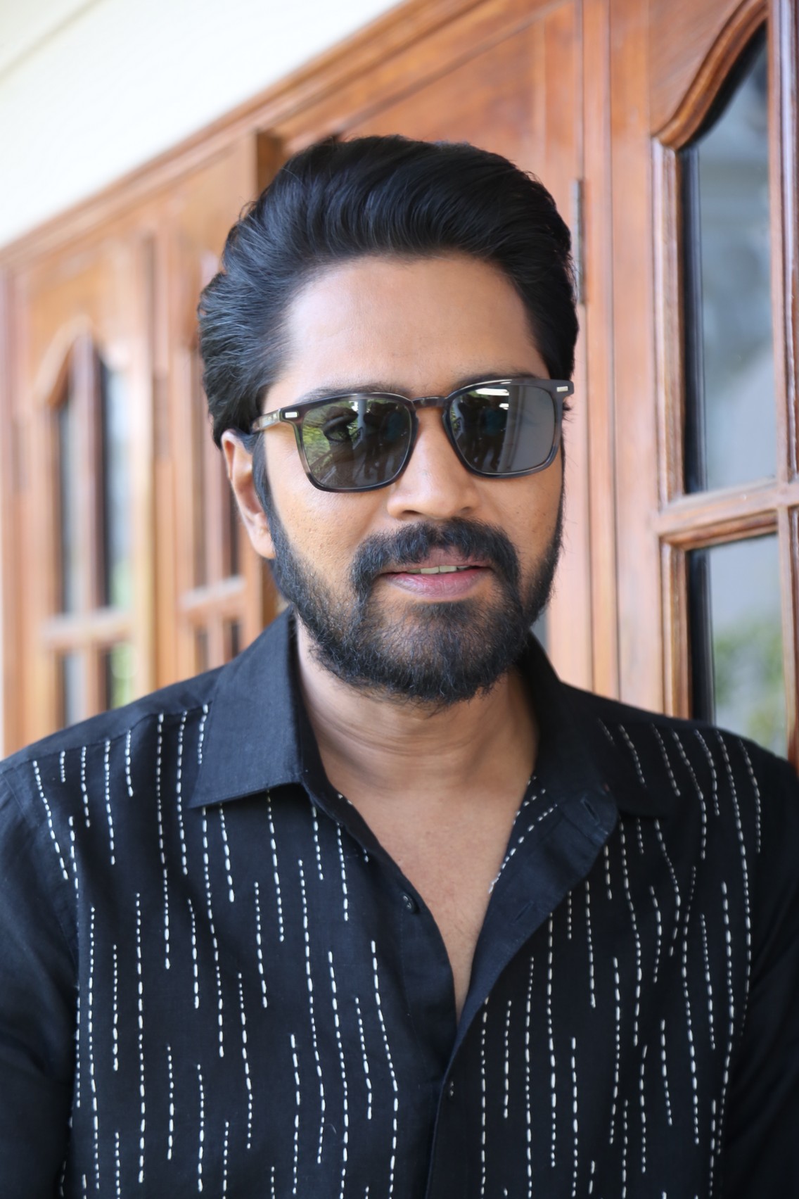 Allari Naresh radiating suave confidence in black attire