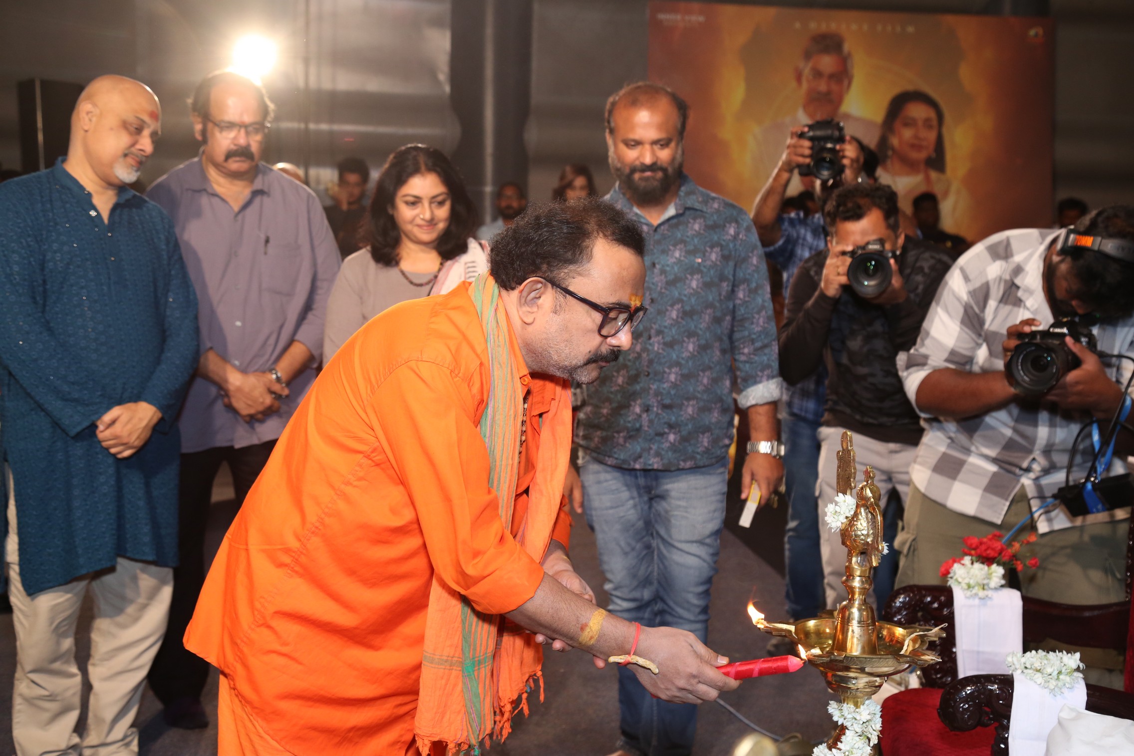 Sai Madhav Burra lighting ceremonial lamp