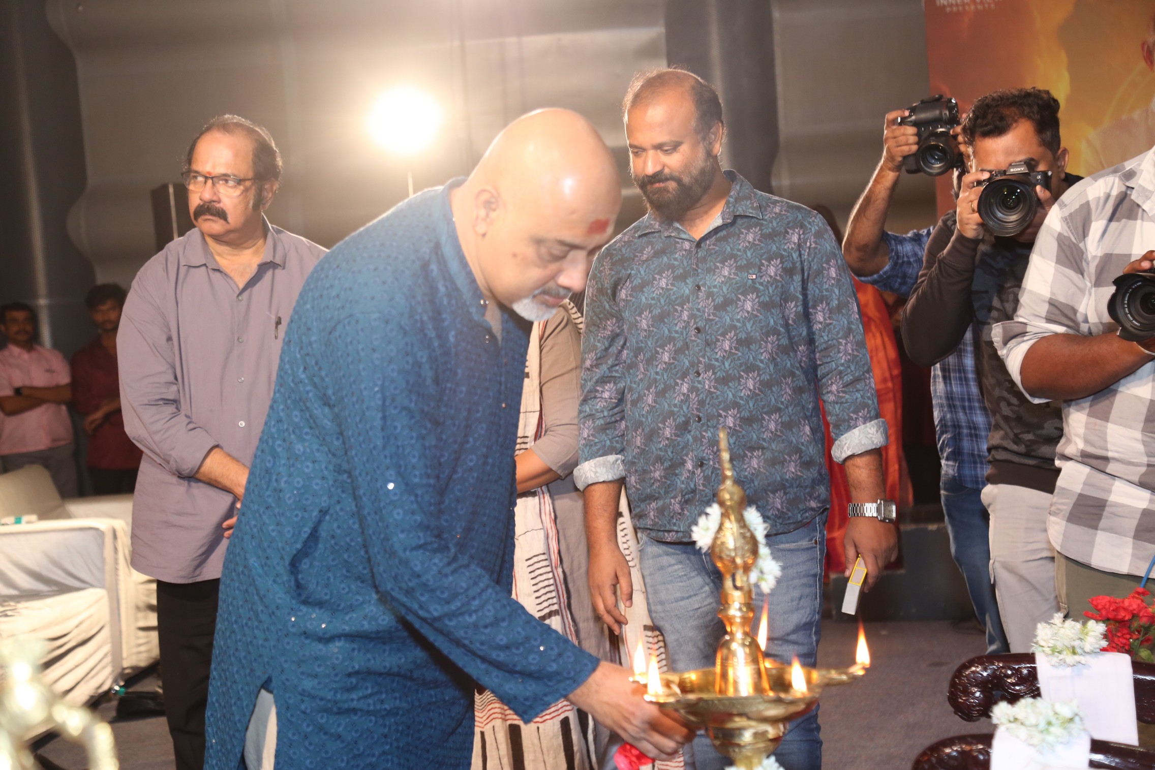 Ramajogayya Sastry lighting ceremonial lamp