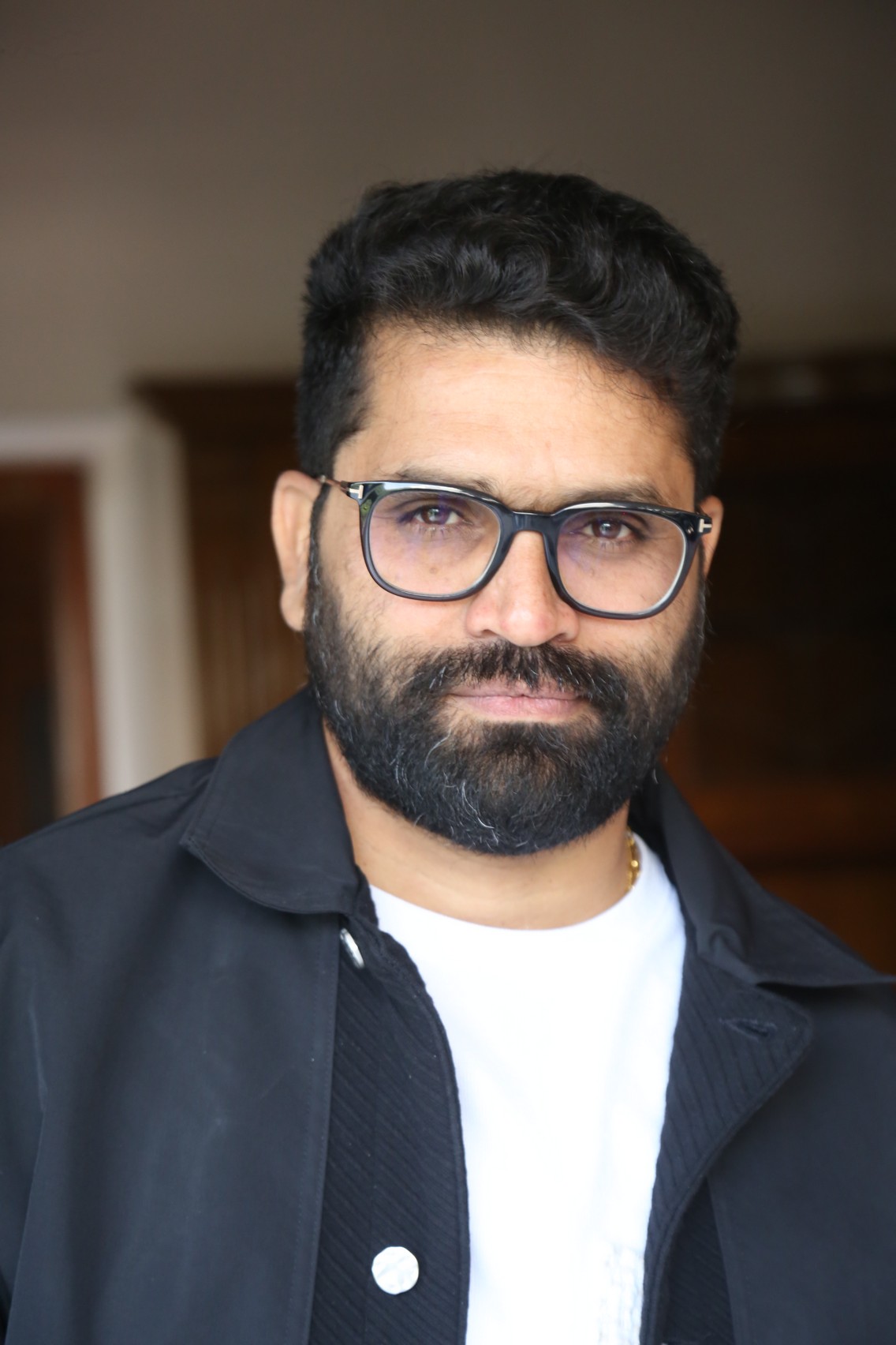 Bheems Ceciroleo sporting confident gaze with iconic glasses