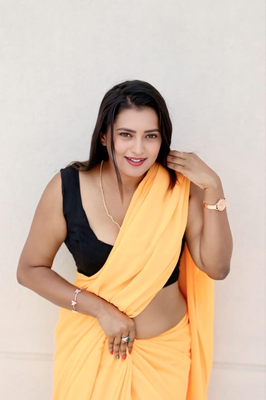 Chaitra Ram glowing in orange with vibrant smile