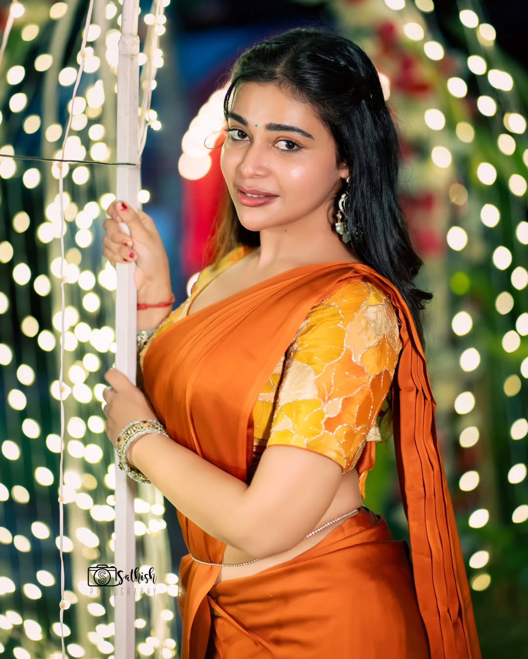 Dharsha Gupta shining in fiery orange with radiant elegance