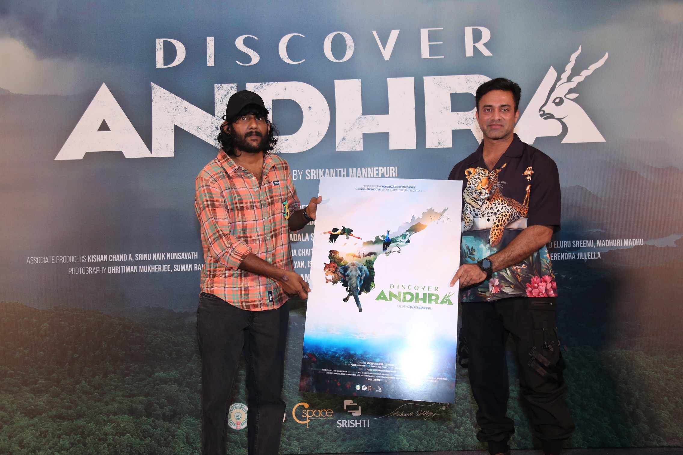 Srikanth Mannepuri and Navdeep posing with Discover Andhra poster