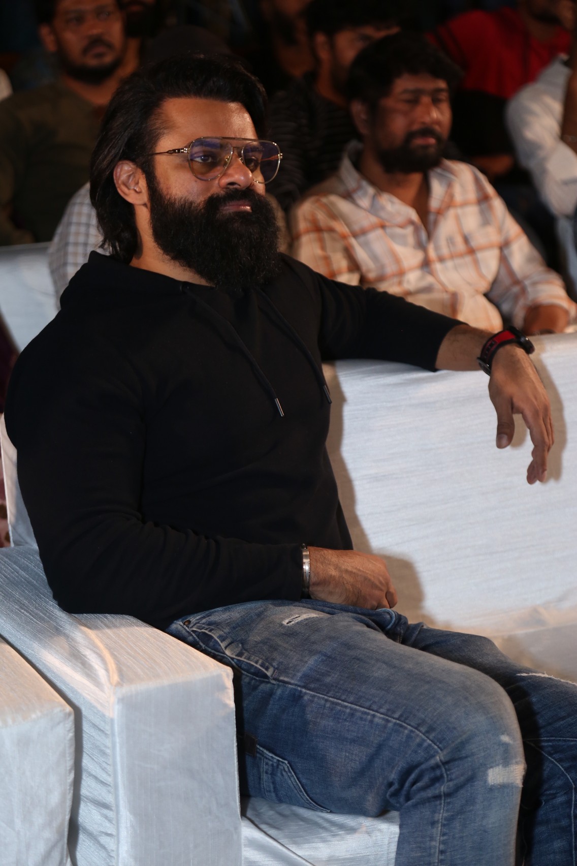 Sai Dharam Tej seated at event