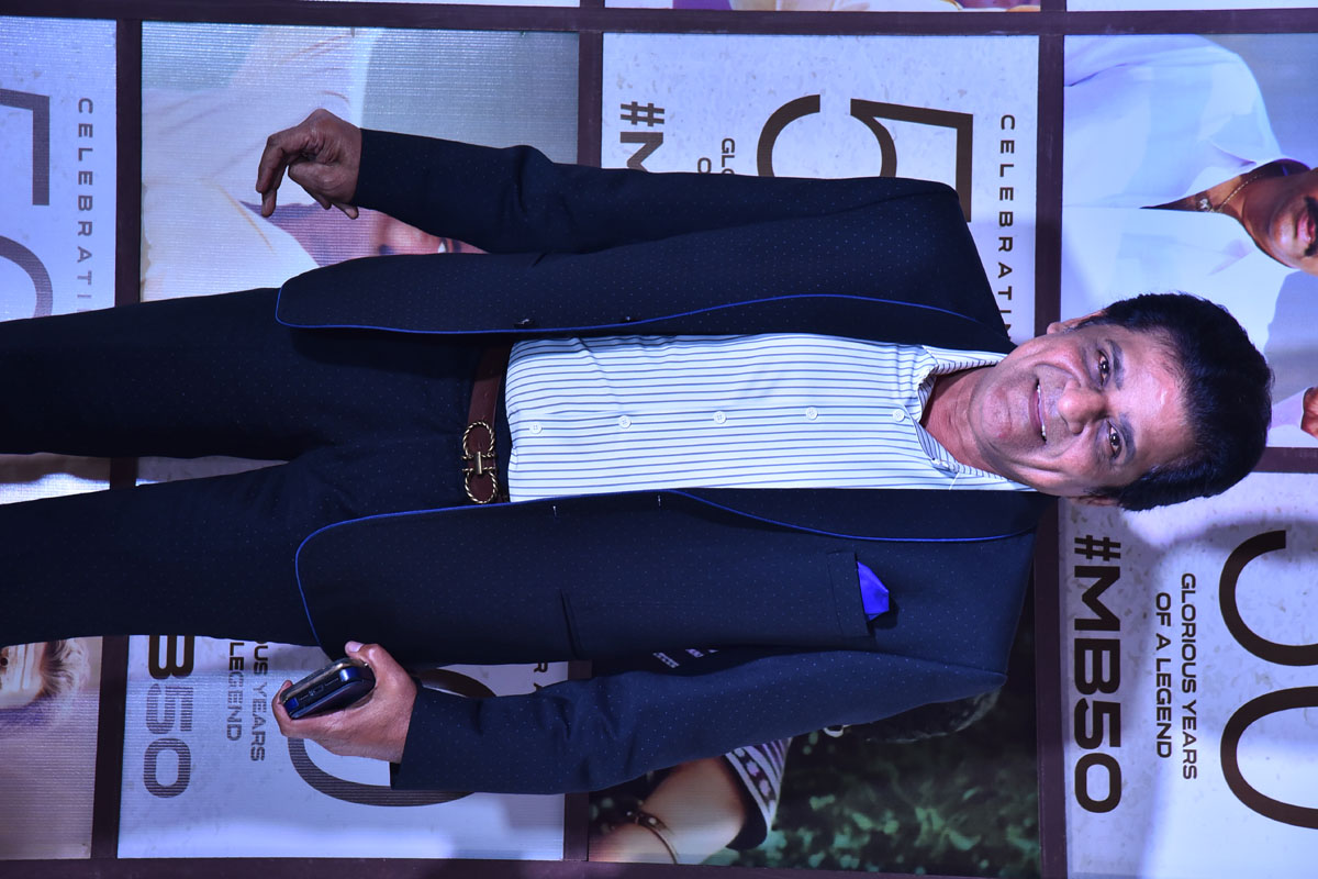 Actor Ali posing with a warm smile for the media.