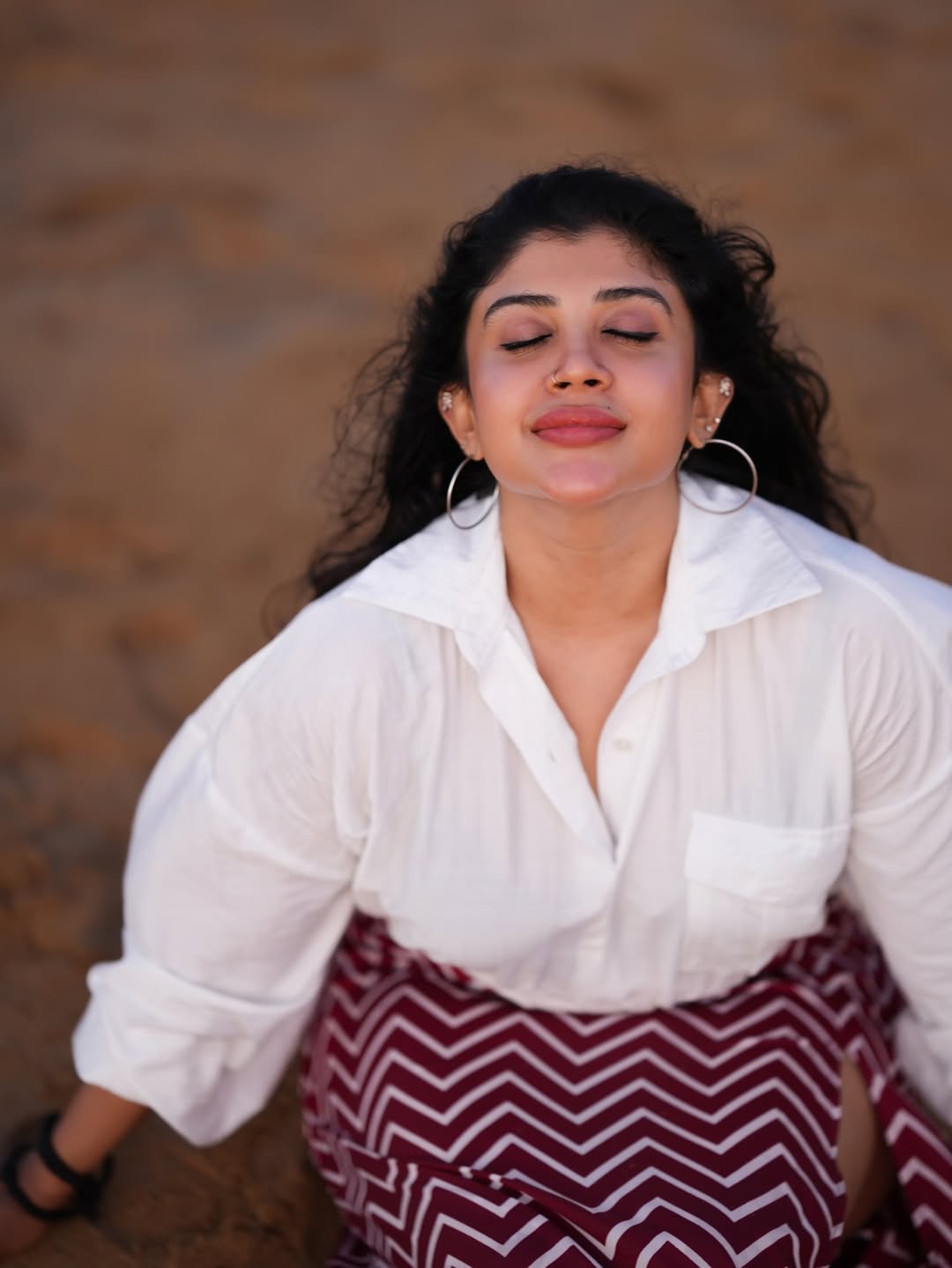 Gayathri Shan shining in white shirt and bold earrings