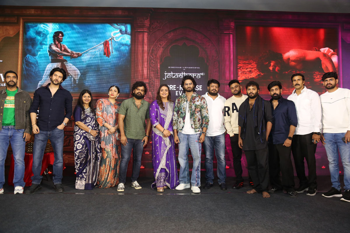 Jatadhara cast and crew posing on stage for photos