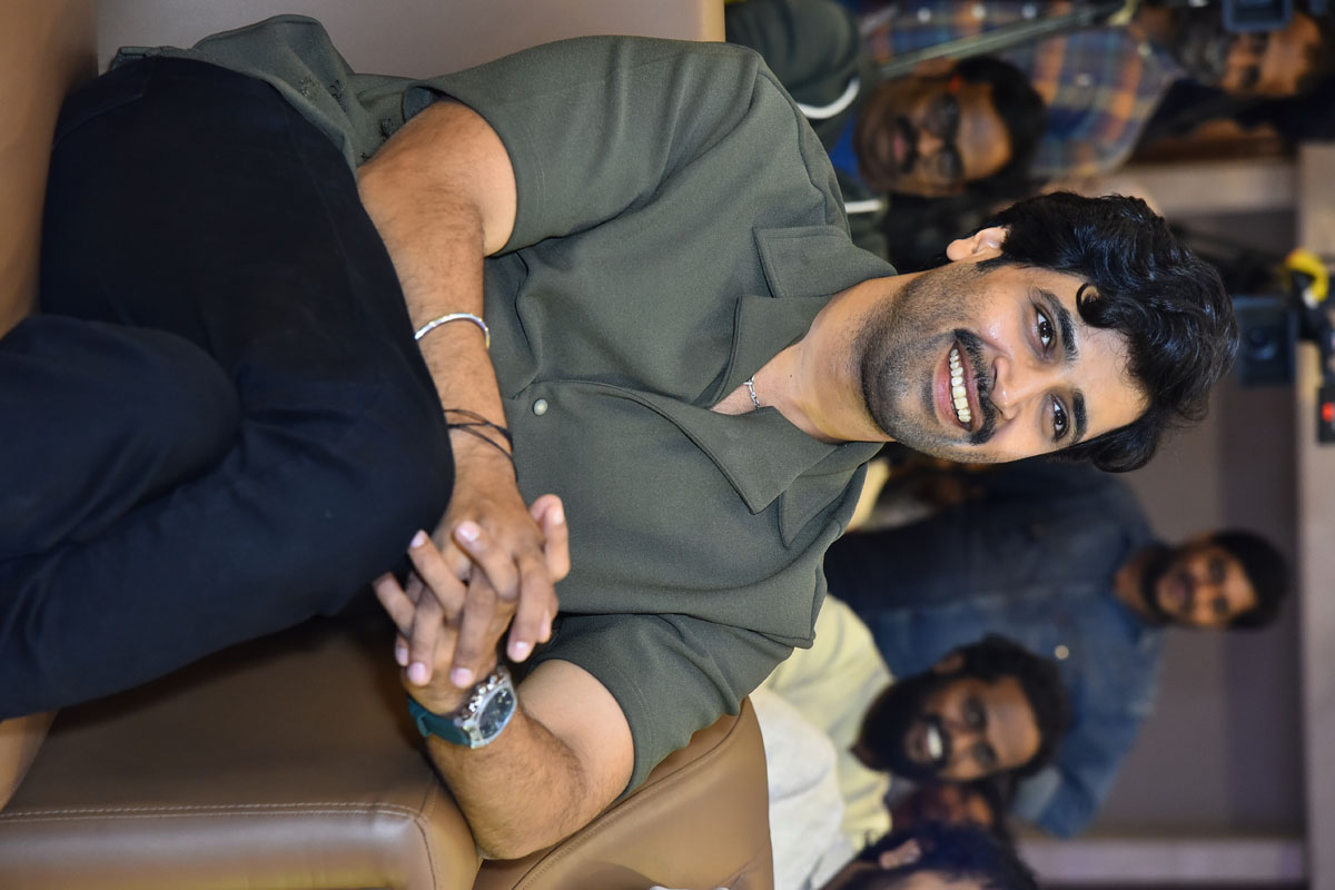 Adivi Sesh seated smiling