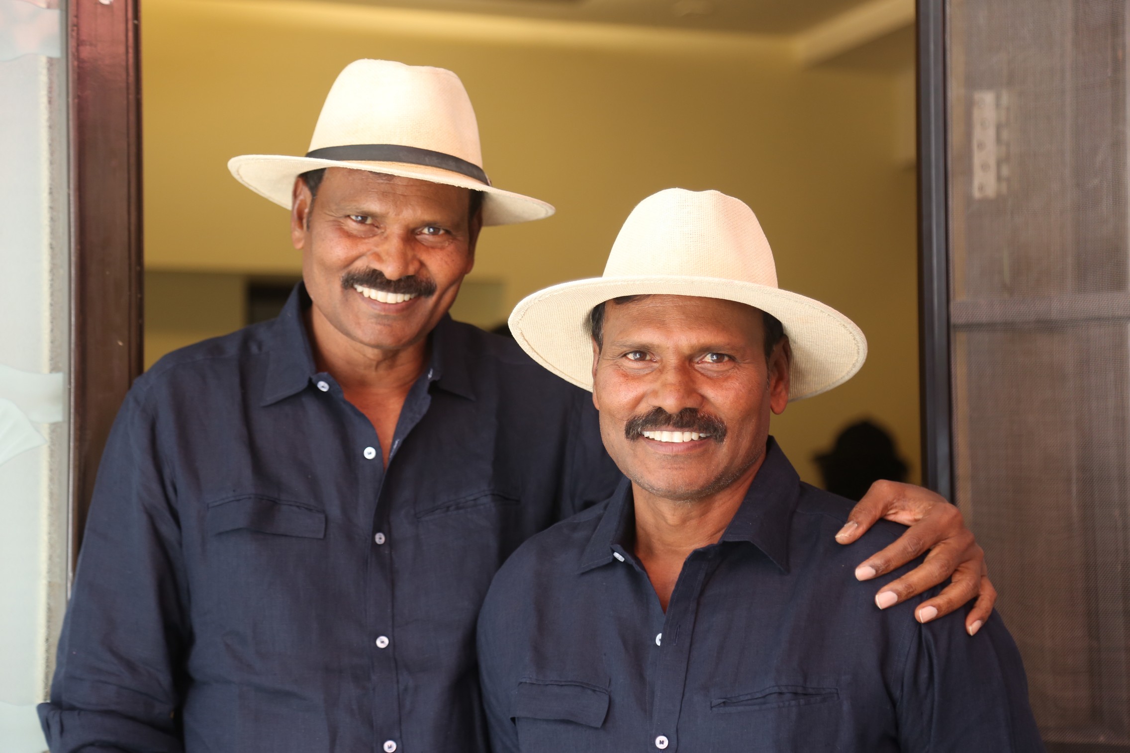 Ram Laxman posing with matching hats and poised expressions