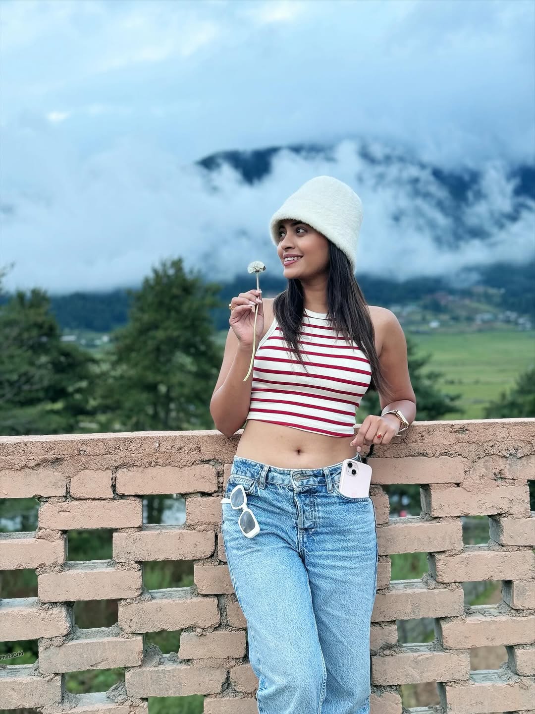 Ruchira Jadhav posing in striped top and jeans