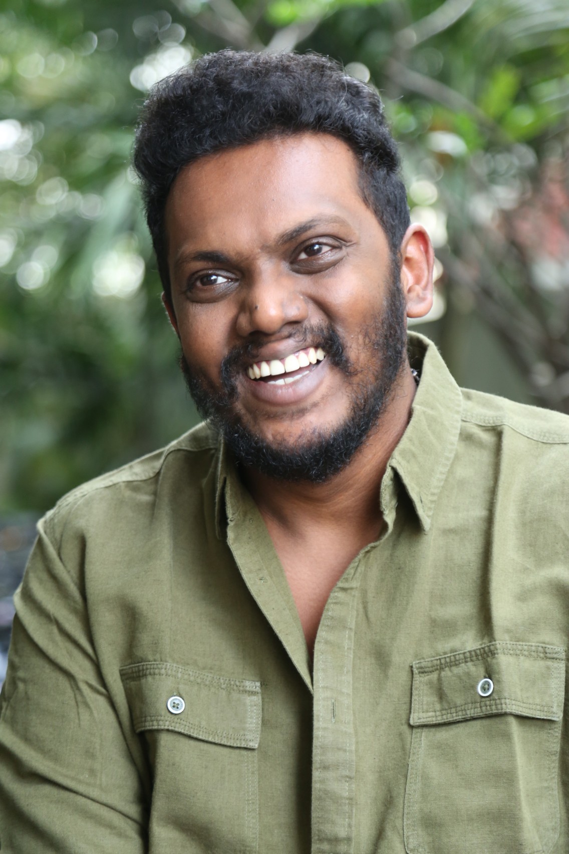Sandeep Raj smiling in well-fitted casual shirt
