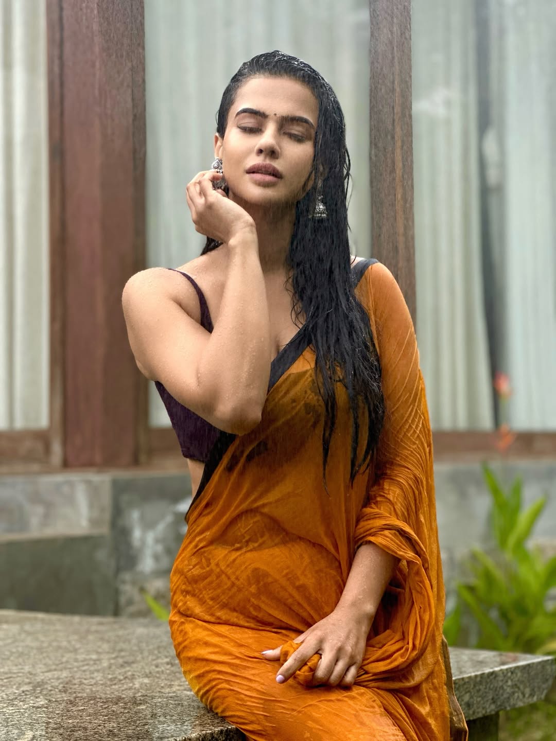Sharmiela Mandre draped in earthy tones with rain-kissed hair