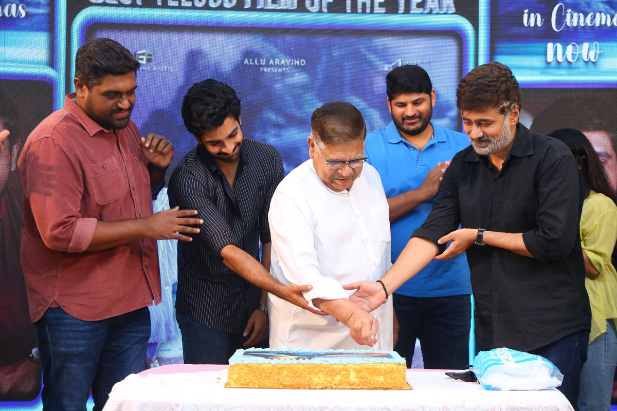 The Girl Friend team celebrating with cake cutting