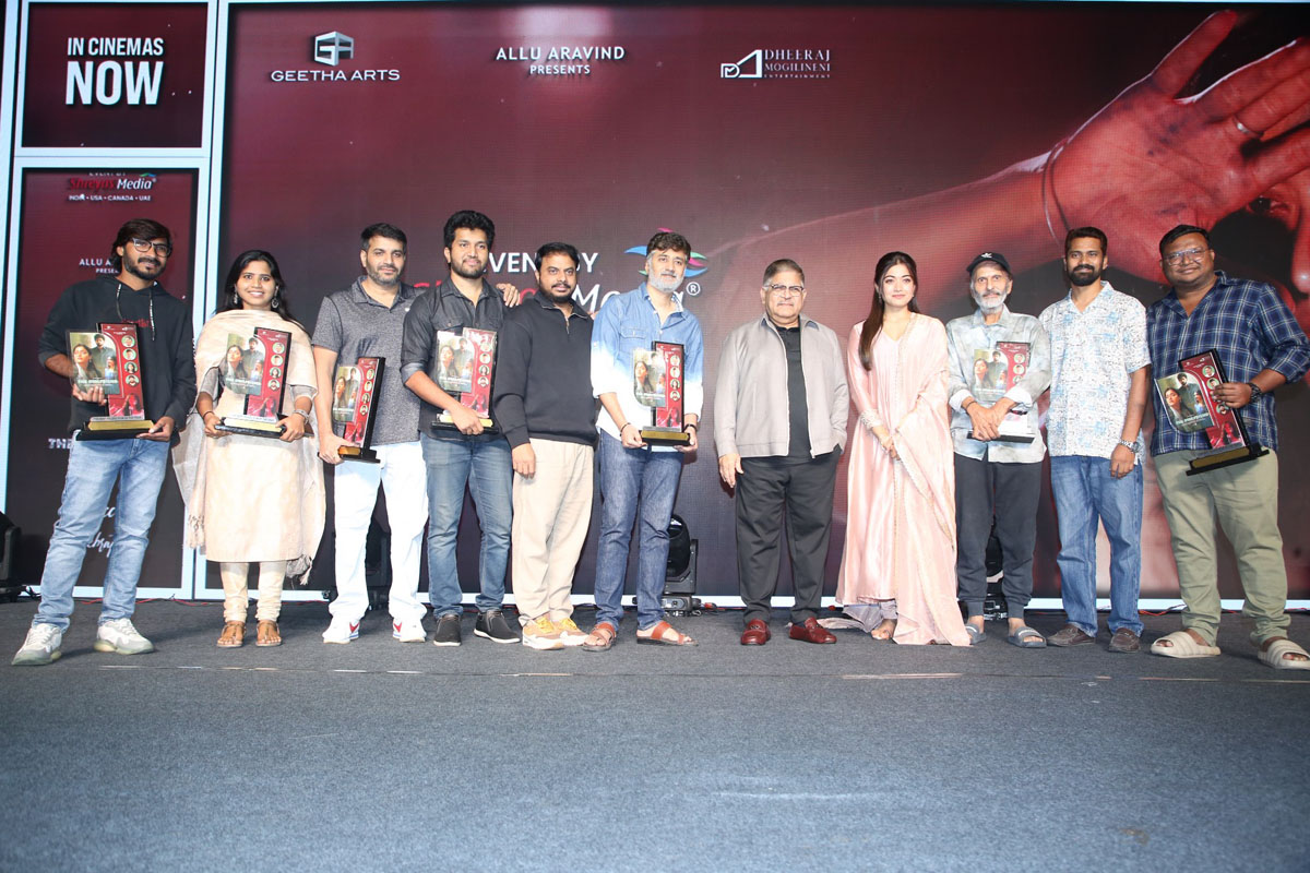 Cast and crew posing together for media