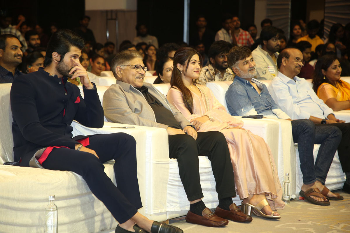 Group seated and smiling at event