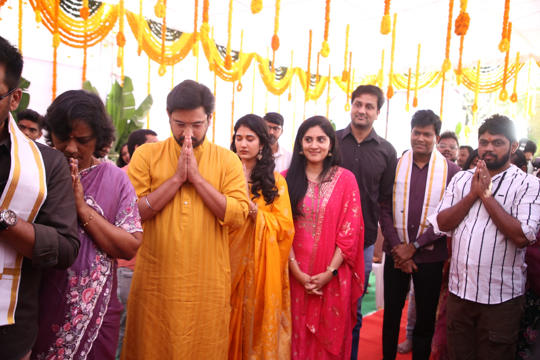 Cast praying during traditional ceremony