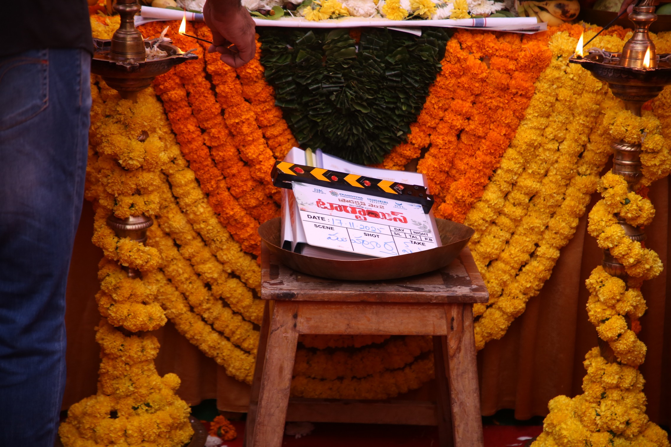 Movie clapboard placed before deity for blessings
