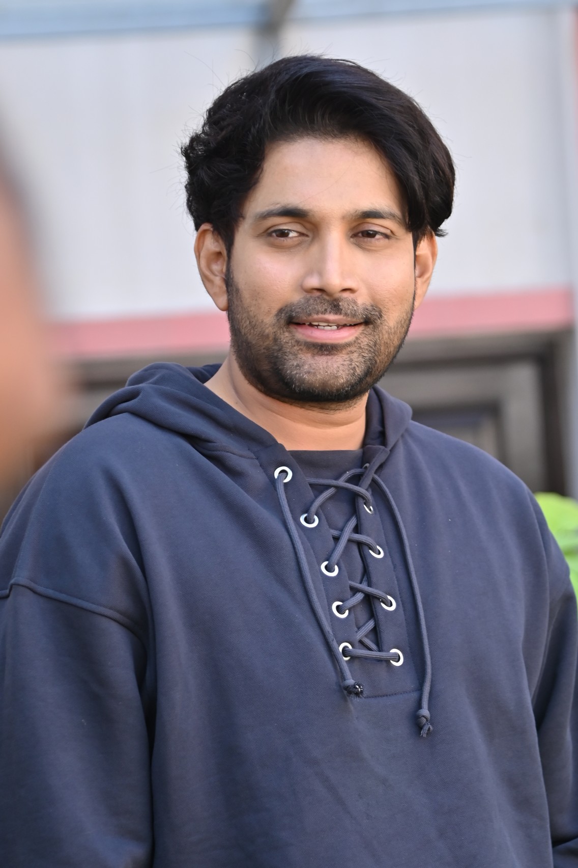 Vikranth Reddy smiling confidently in casual hoodie look