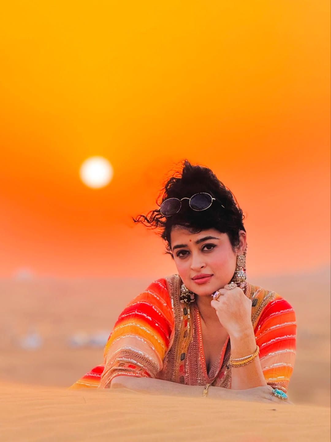 Apsara Rani glowing stylishly against dramatic sunset backdrop