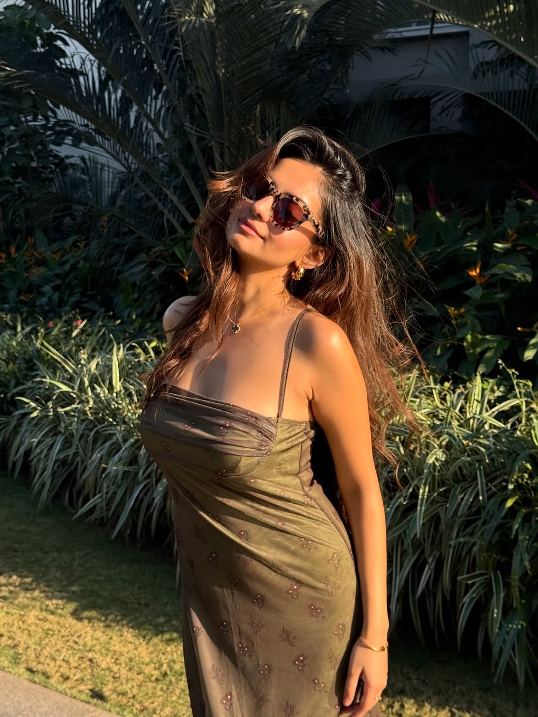 Anushka Sen posing stylishly in earthy tone dress