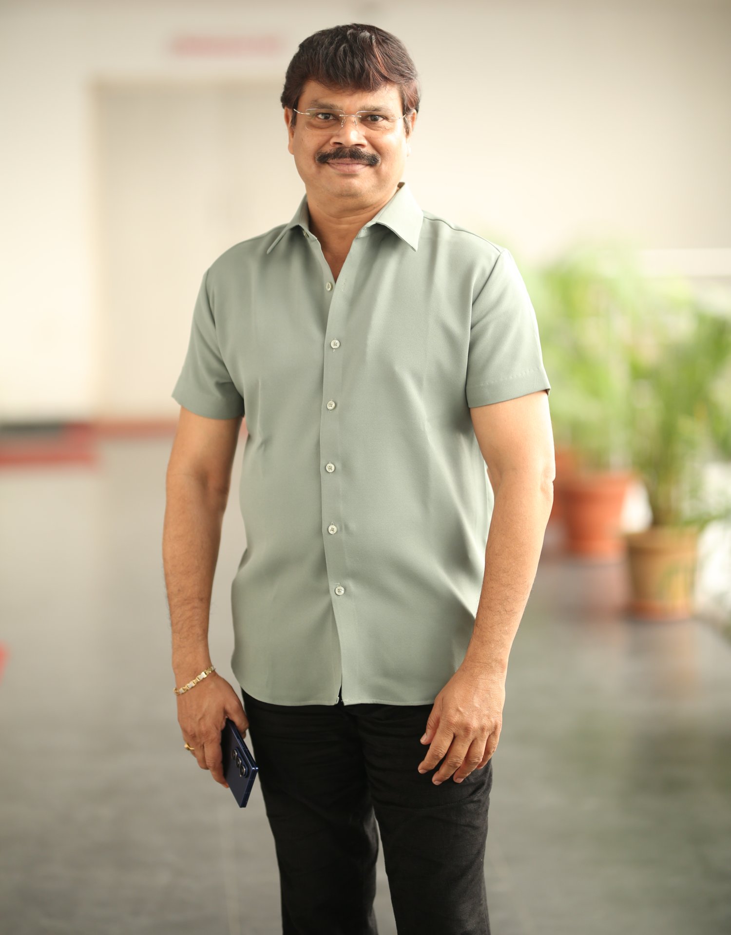 Boyapati Srinu showcasing casual style with subtle smile