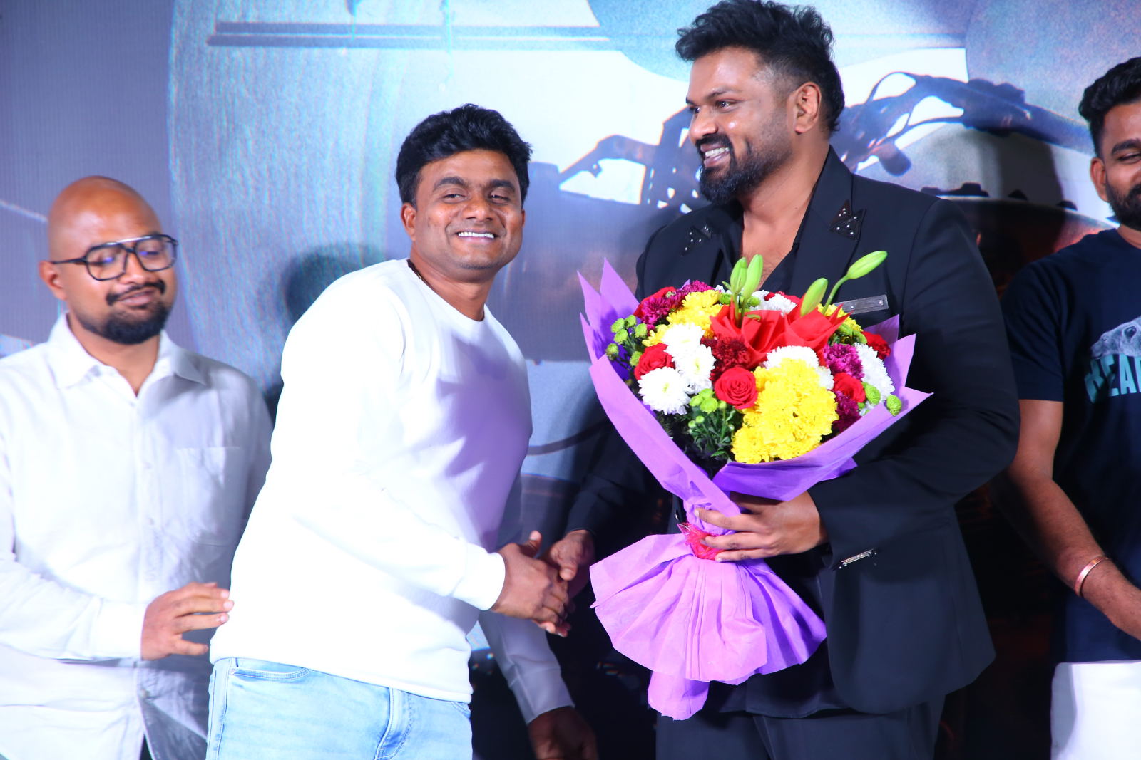 Producer Venkata Reddy presenting bouquet to Manchu Manoj
