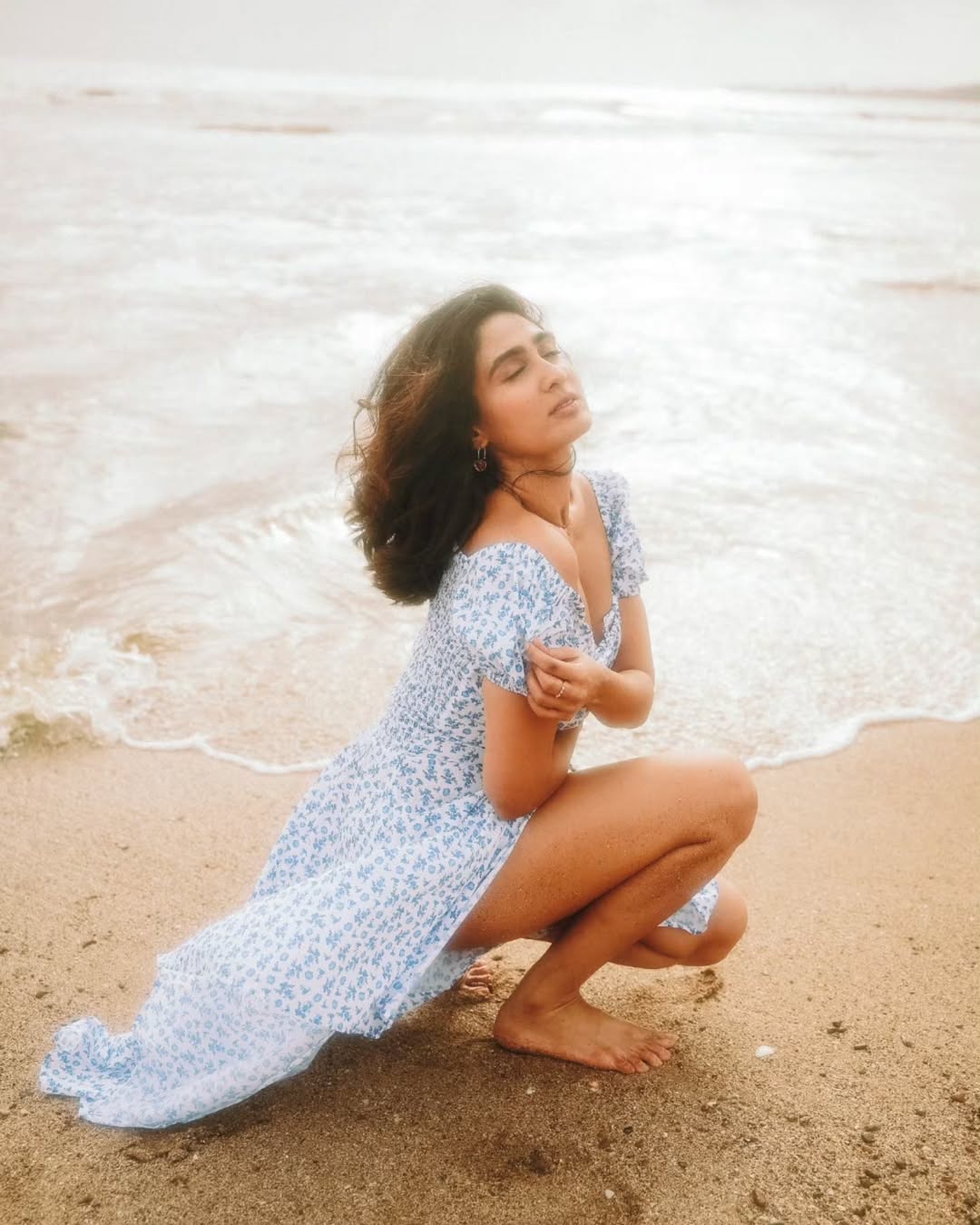 Deepti Sati beachside elegance in chic squatting pose