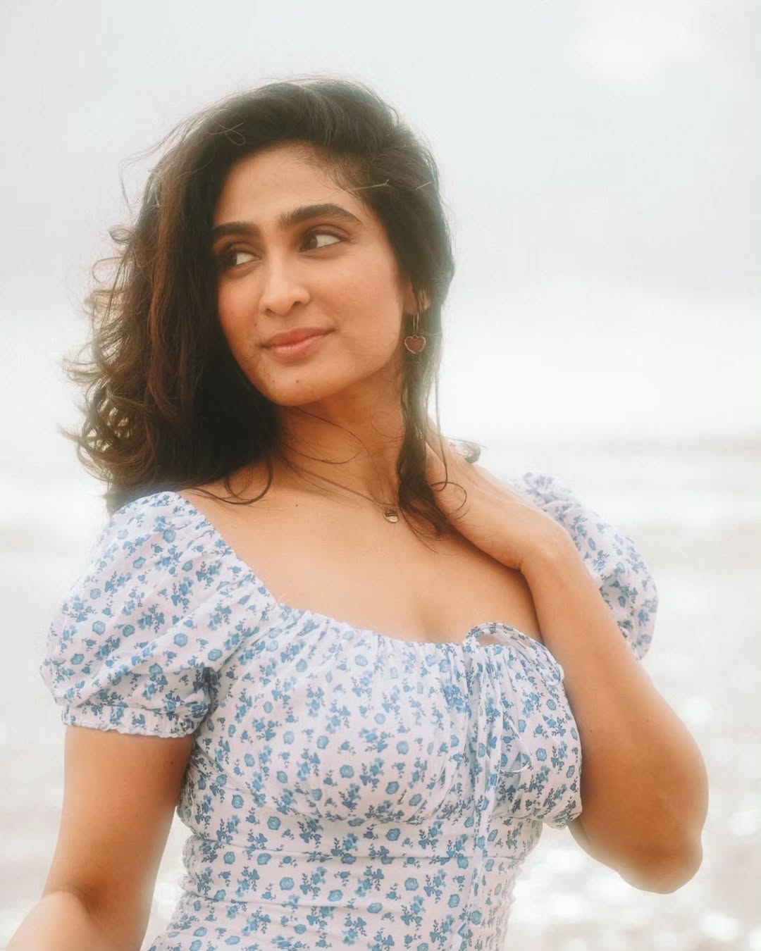 Deepti Sati confident in breezy dress near shoreline