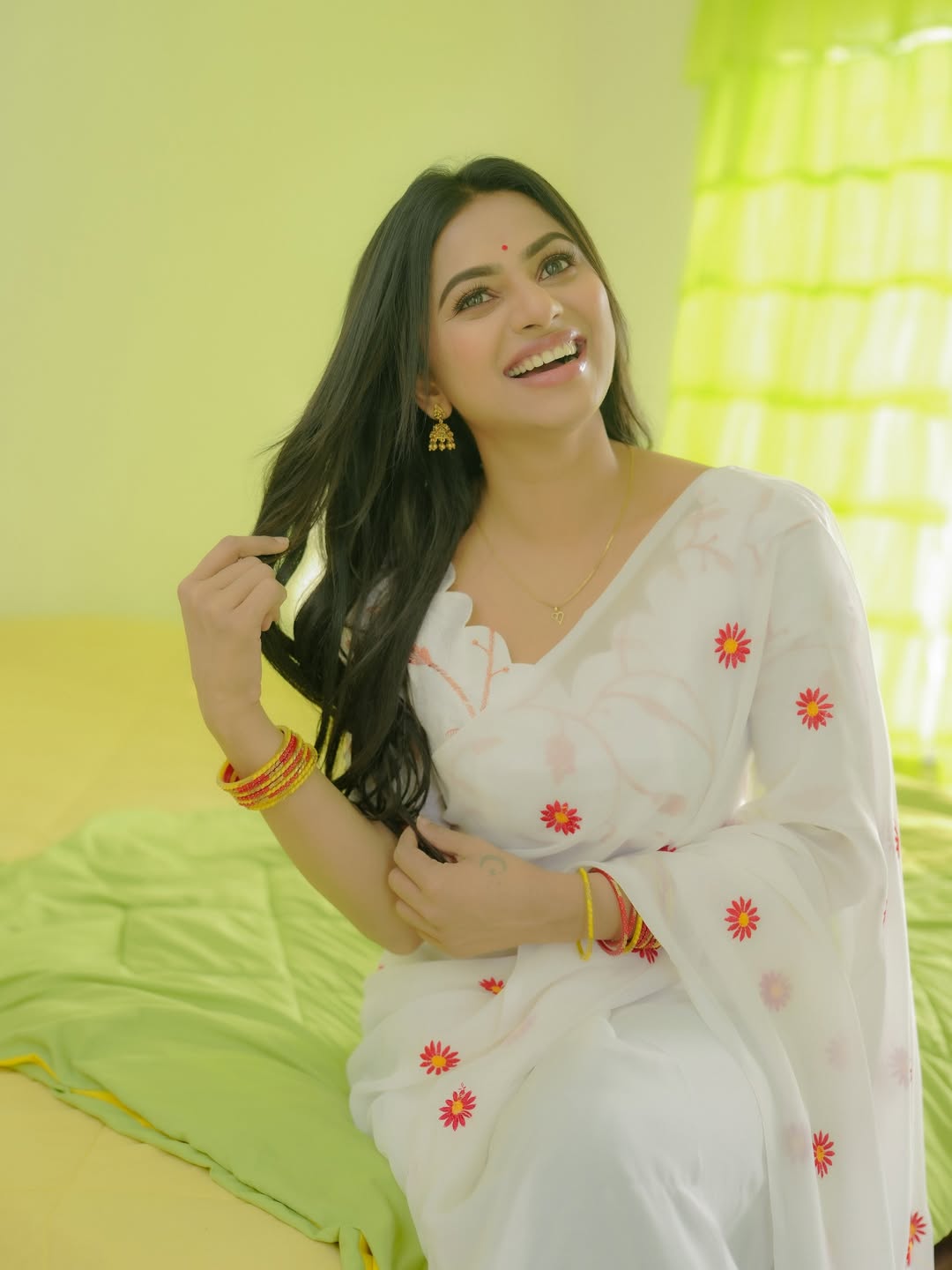 Delna Davis smiling gracefully in floral traditional attire