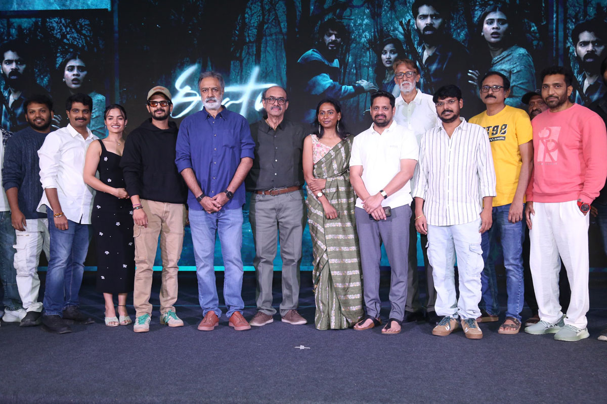 Cast and crew posing for media photos