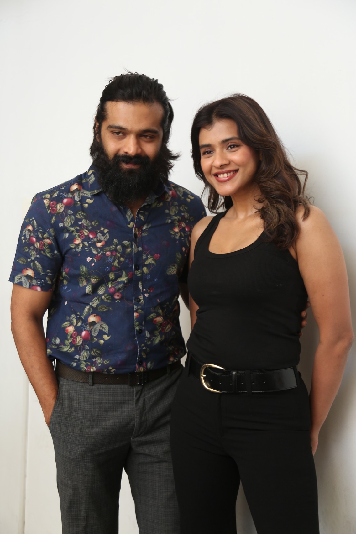 Thrigun and Hebah Patel posing together at media event