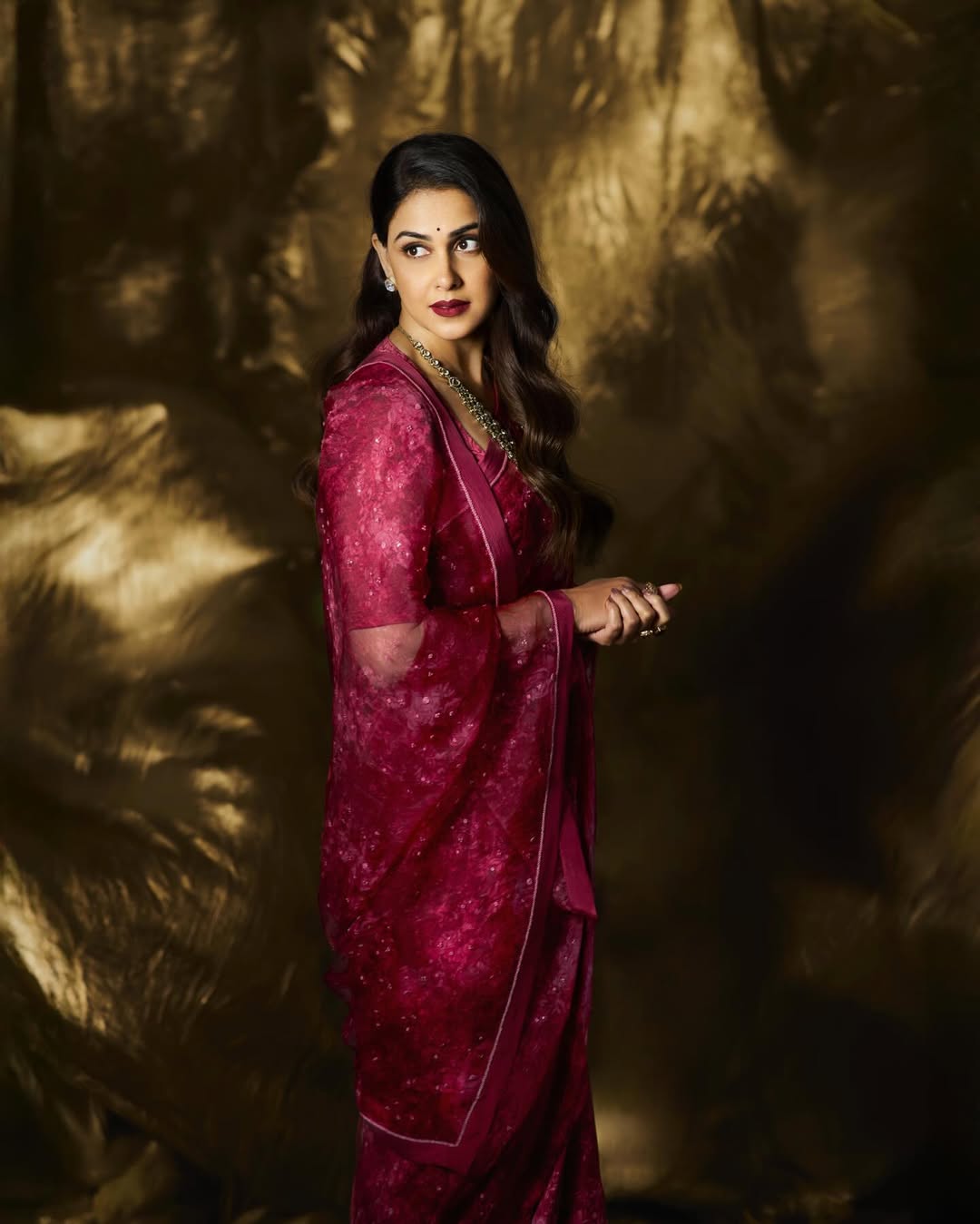 Genelia D'Souza showcasing timeless maroon saree look indoors